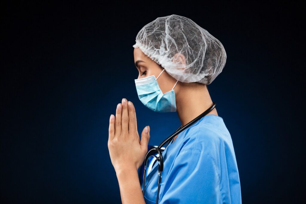 side-view-praying-doctor-isolated-black