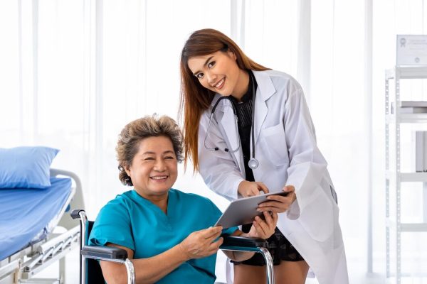 asian-medical-doctor-take-care-explain-senior-elderly-woman-female-patient-wheelchair-with-tablet-looking-camera_554837-54